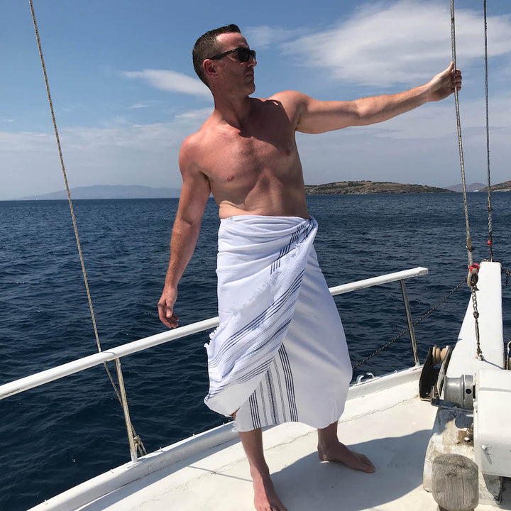 man on deck wearing white dina terry backed towel